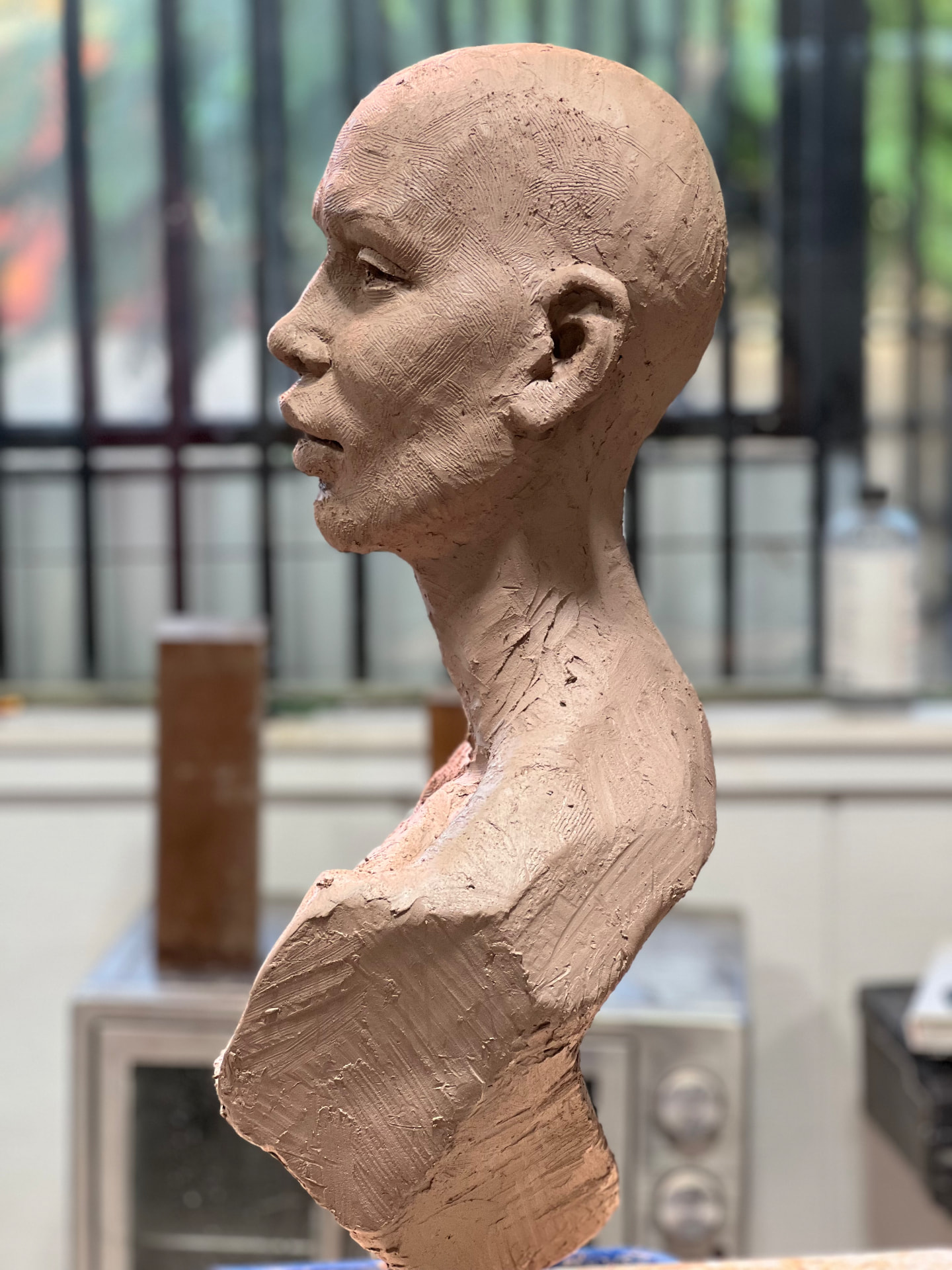 Clay profile bust of SHUDU in progress in the studio
